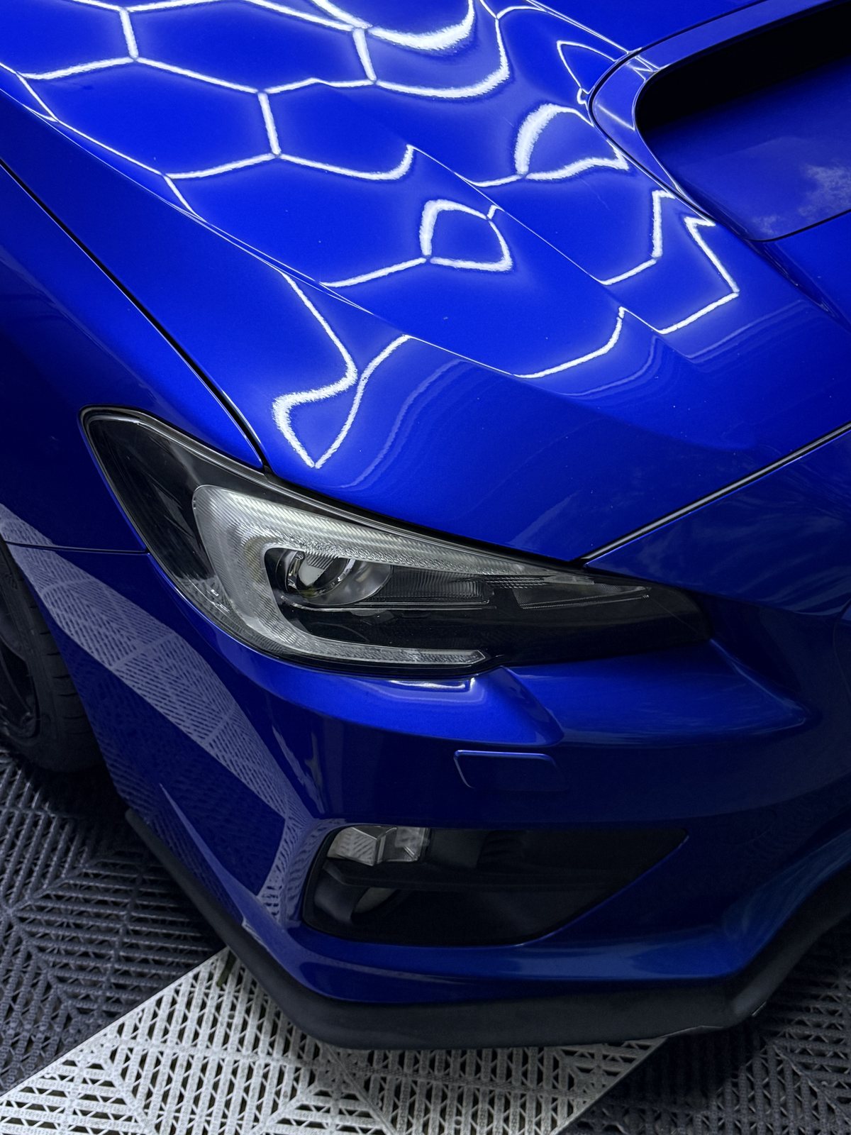 Gloss on a Subaru WRX front end after paint enhancement