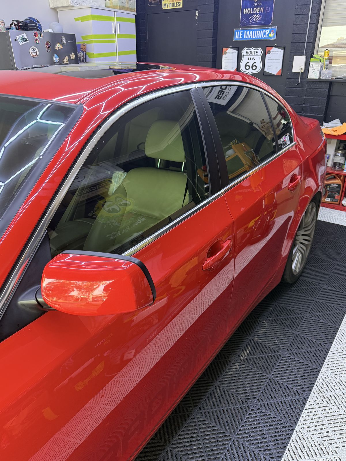 Tinted side glass on a red BMW 5 Series