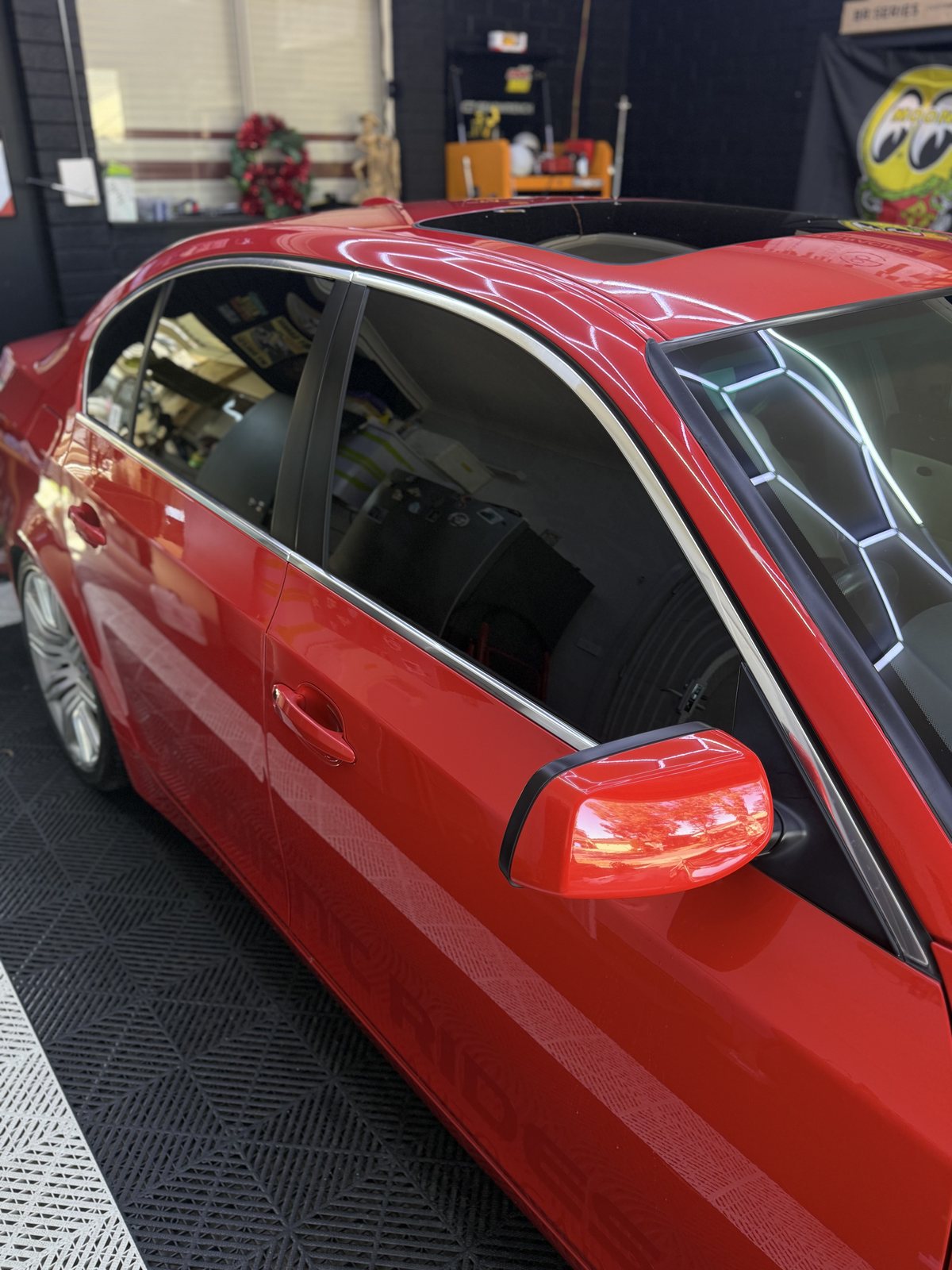 Tinted side windows on a red BMW 5 Series