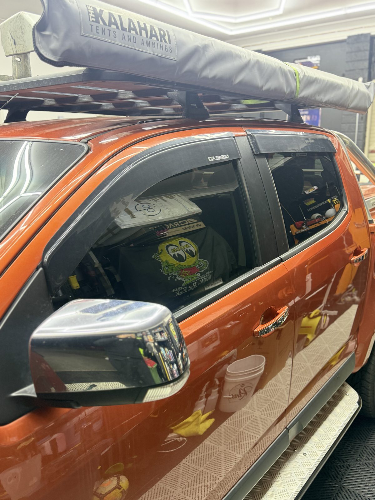 Tinted front and rear side windows on an orange Holden Colorado